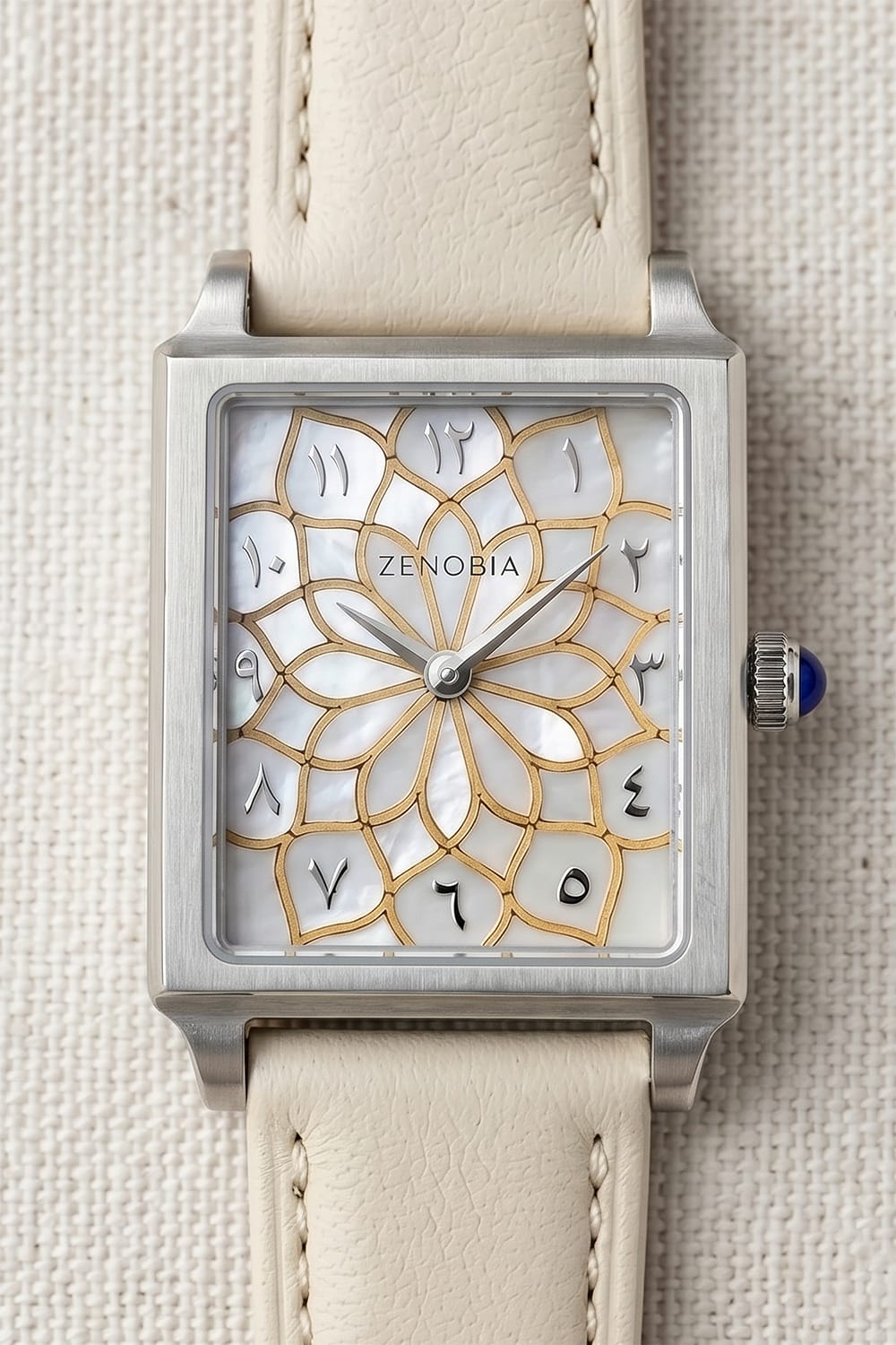 Close-up of the floral pearl and gold-toned Zenobia dial